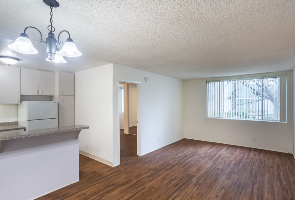 Windward Village Apartments unfurnished living area with window Windward Village Apartments unfurnished living area with window